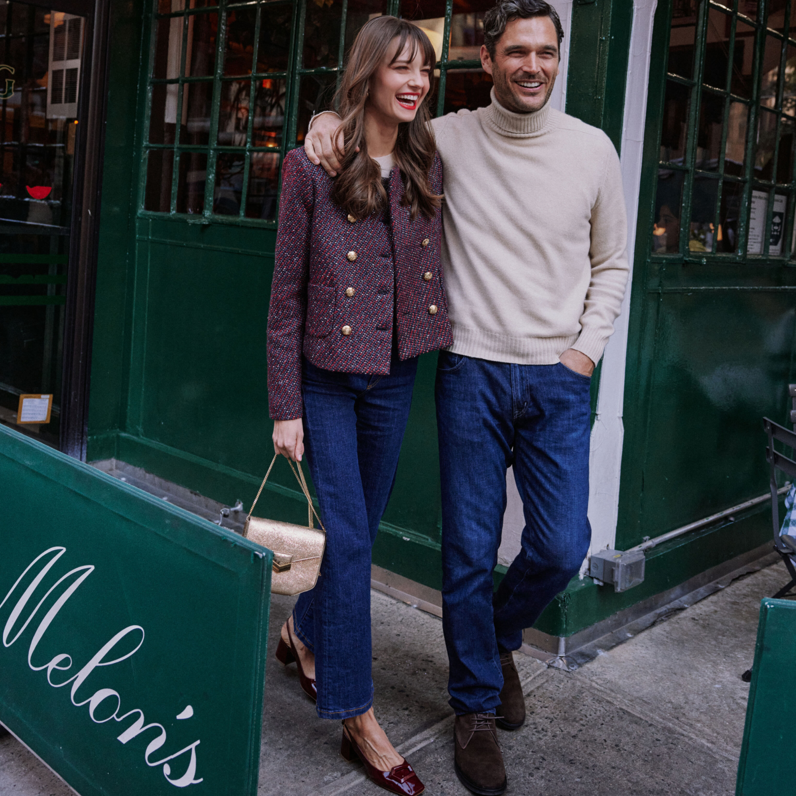 A stylish couple in classic, effortless fall outfits, embodying high-end fashion and fun, walks past Melon’s store, showcasing Metrobazaarstore's chic, confident style.