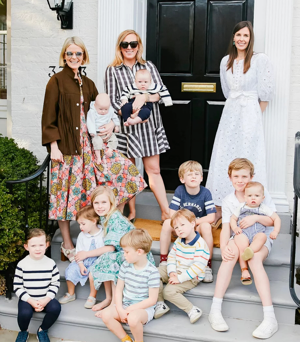 A classic family portrait on house steps features women in patterned dresses holding babies, surrounded by children in effortless, fun spring attire. House number 333 visible.
