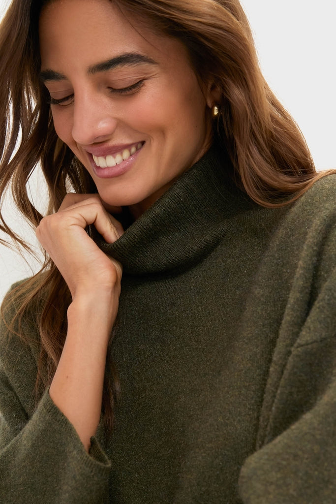 Young woman wearing the classic Moss Green Vivianne Dress, an effortless, high-end turtleneck sweater with a cozy, fun vibe, perfectly embodying Metrobazaarstore's style.