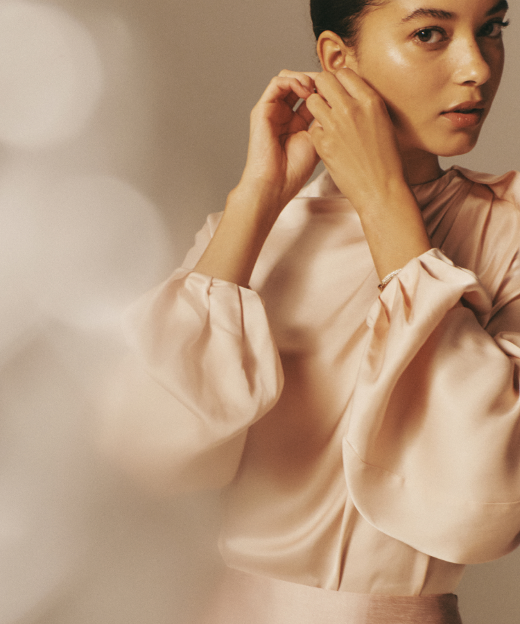 Woman in a blush top. 