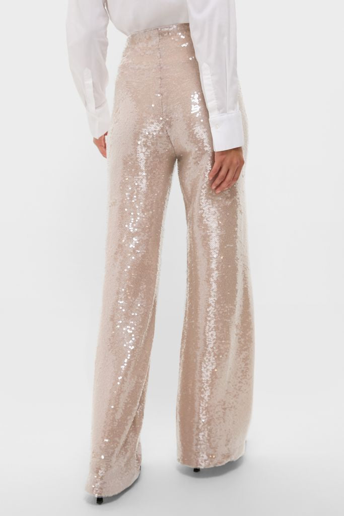 Back view of a person in high-waisted, wide-leg Champagne Sequin Tatum Pants, paired with a white shirt, showcasing classic, effortless elegance for high-end, fun occasions.