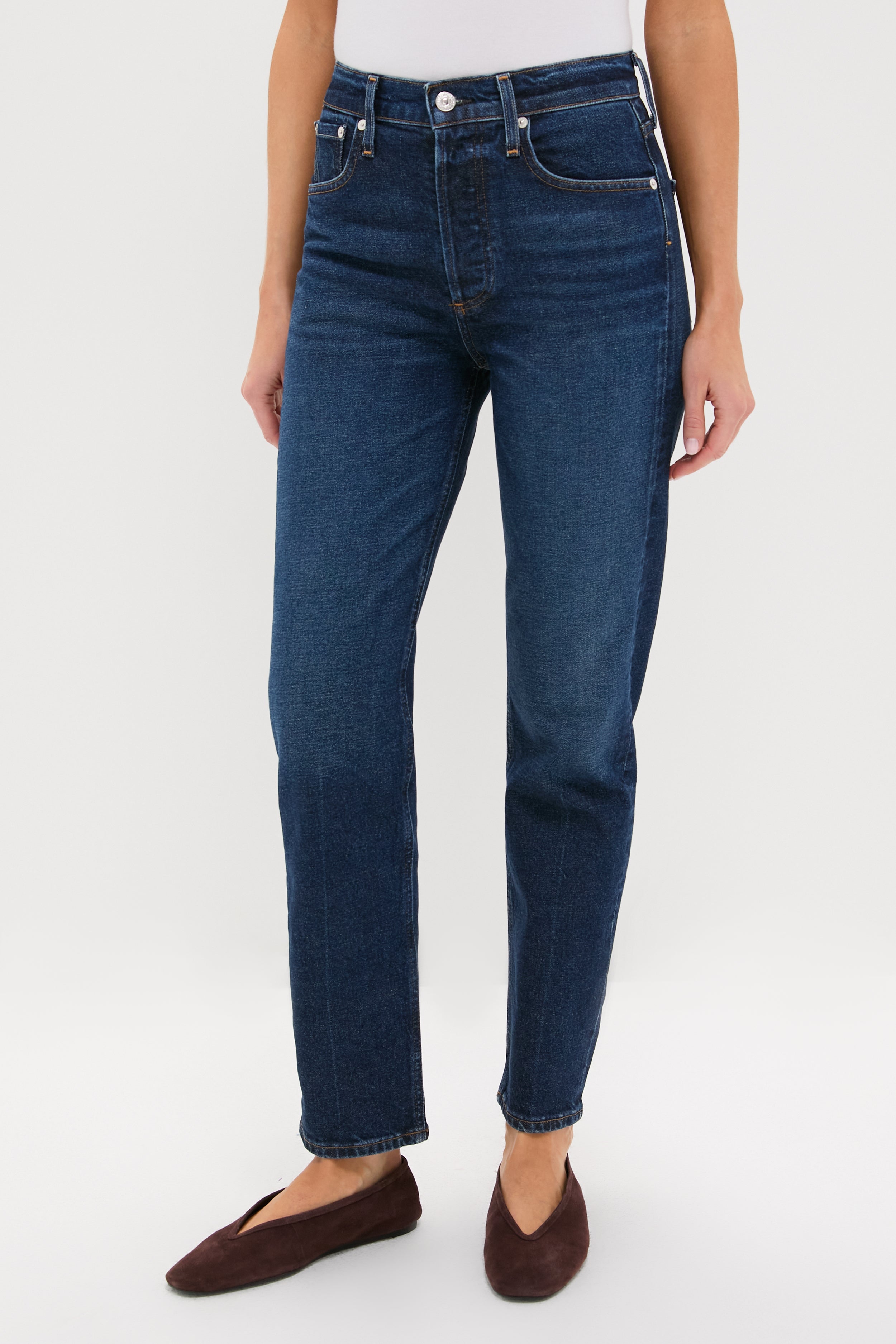 Model wears Sutherland Blaine Jean, classic high-rise, straight-leg denim with a clean hem. Effortless and high-end, perfect for a fun, versatile wardrobe.