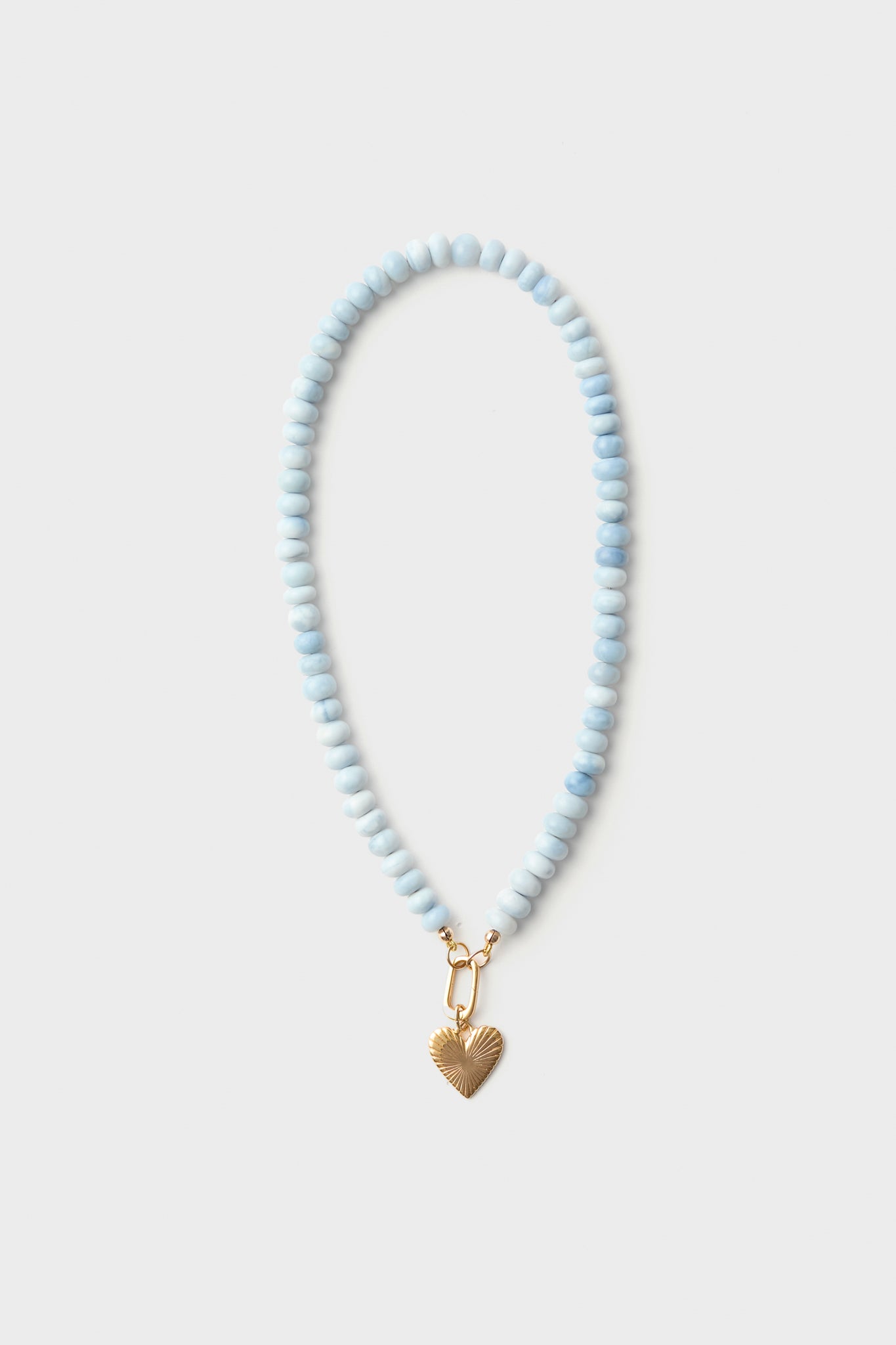 A HART for Metrobazaarstore exclusive beaded necklace with light blue opal beads and a gold heart charm.
