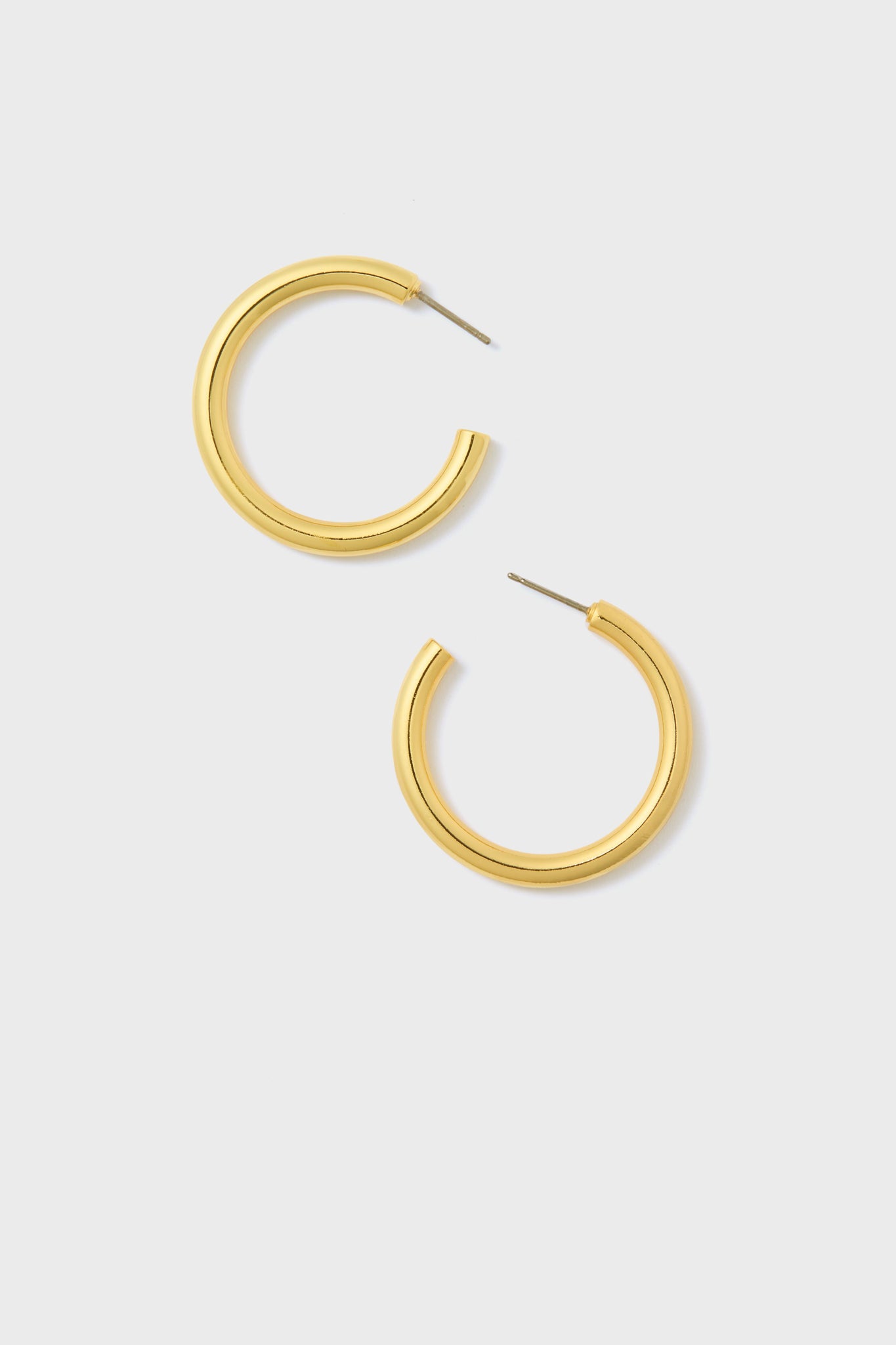 A pair of hypoallergenic gold hoop earrings by Metrobazaarstore Jewelry is elegantly displayed.