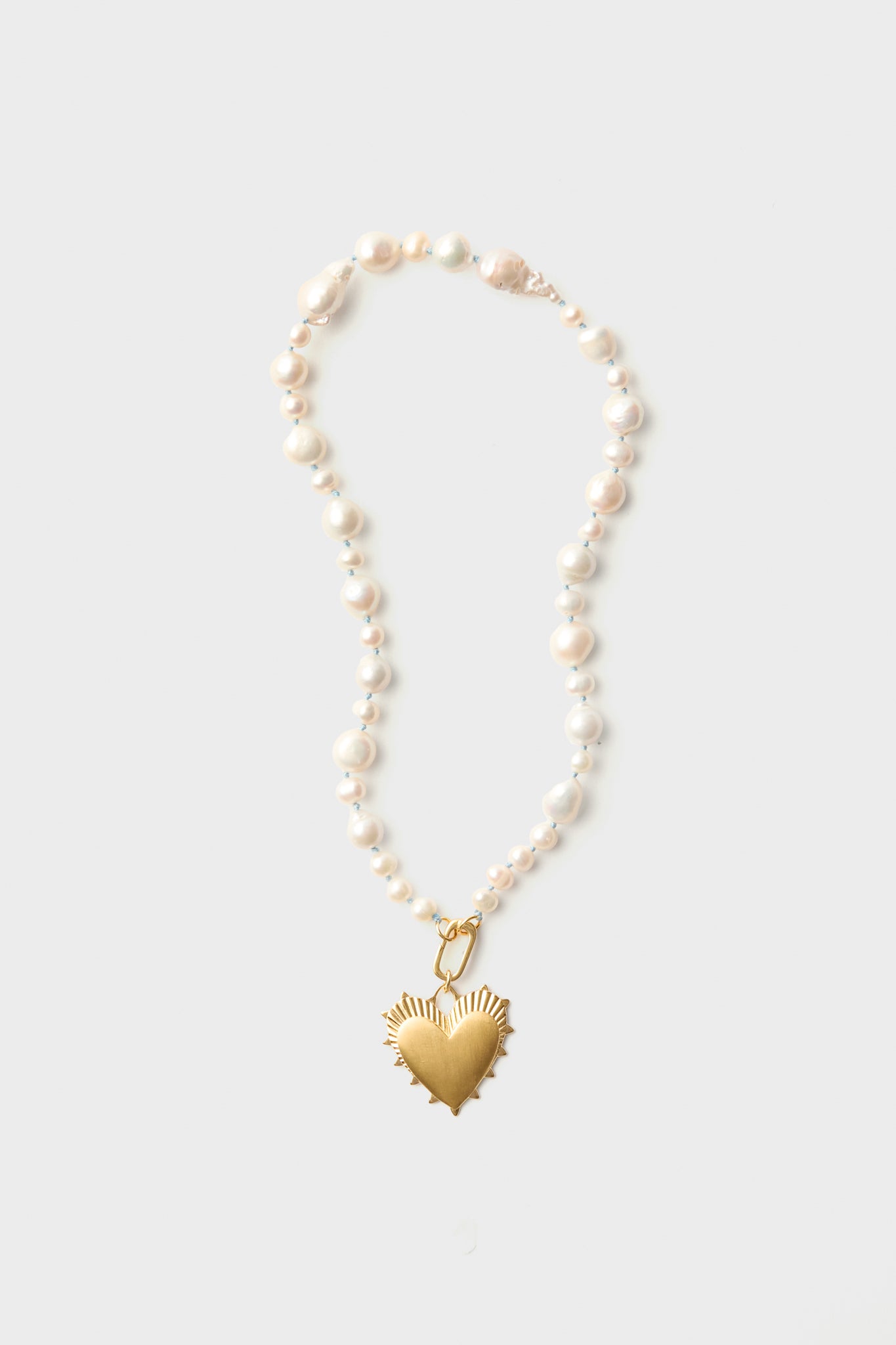 A HART Baroque pearl necklace with irregular white hand-knotted pearls and a gold heart charm.