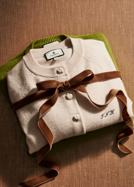 Stack of cashmere sweaters tied with a velvet ribbon. 