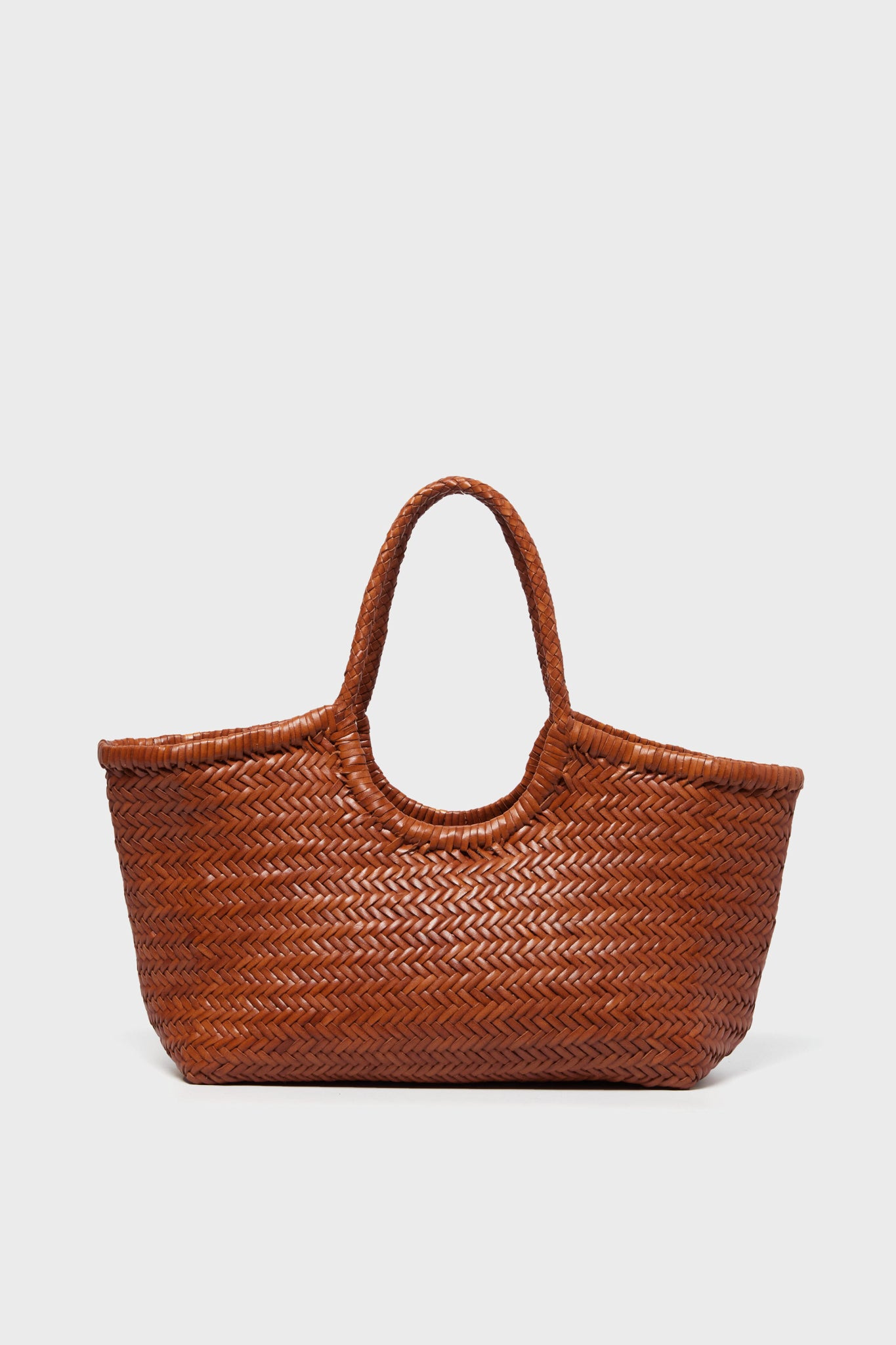 A brown handwoven tote basket bag by Dragon Diffusion is shown, featuring two handles and crafted with intricate detail.