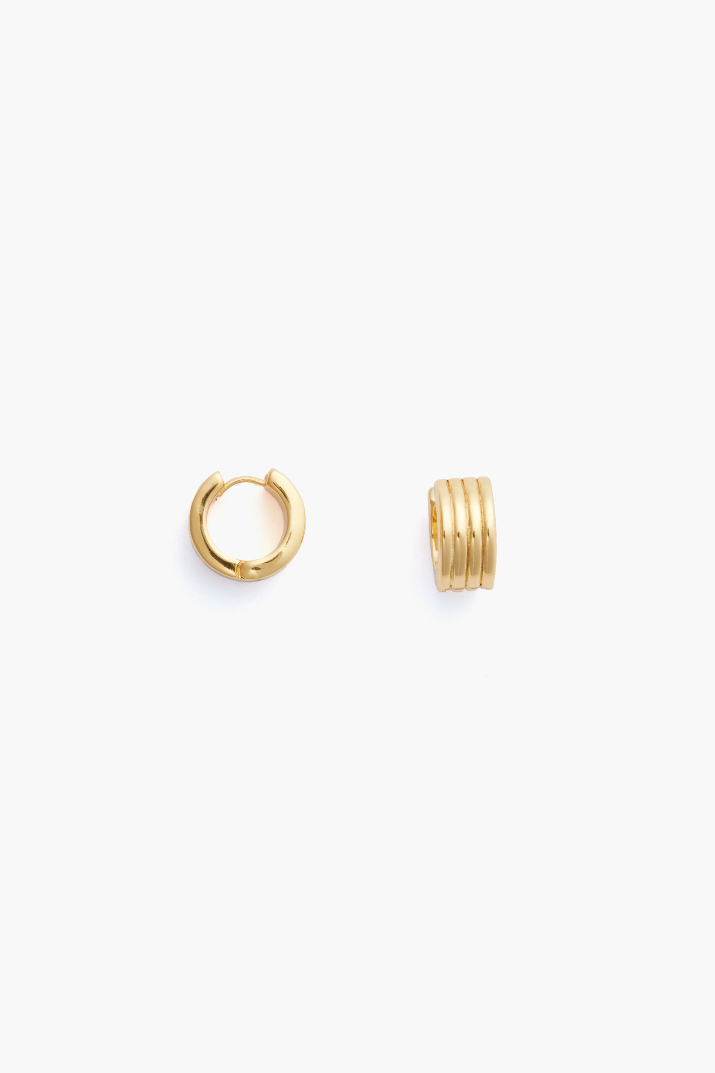 Two small gold hoops from Metrobazaarstore Jewelry, one open and one closed, feature a ridged, segmented design—perfect as stackable earrings or worn as Gold Infinity Huggie Earrings.