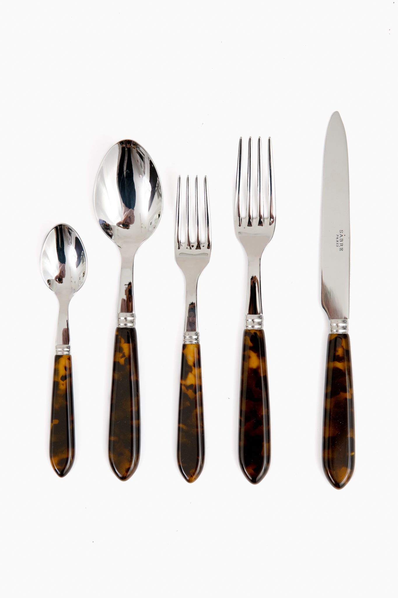 The Sabre Paris five-piece cutlery set features 18/10 stainless steel with dark brown marbled handles and includes a small spoon, large spoon, small fork, large fork, and knife, all arranged side by side.