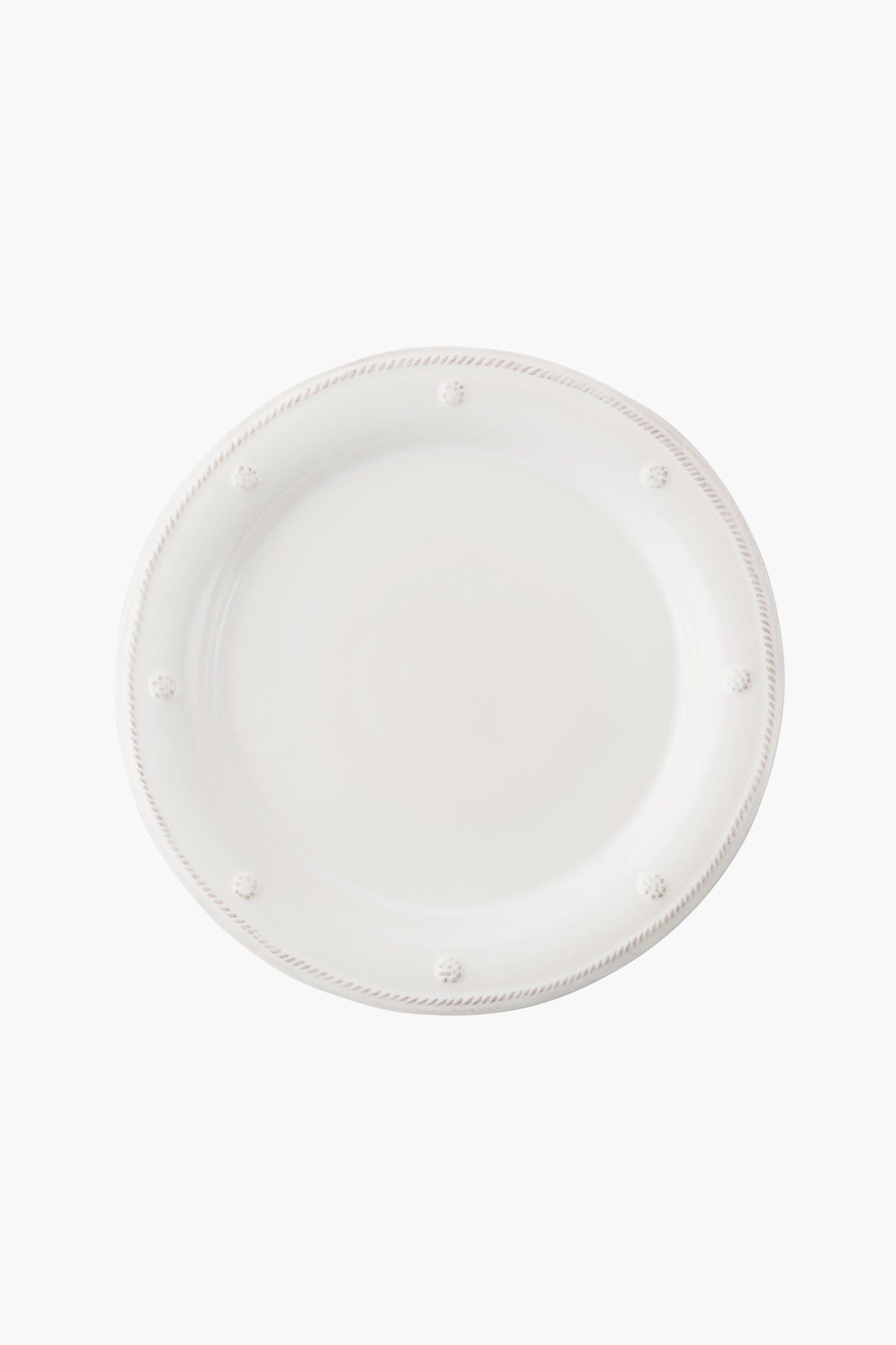 A round, plain white ceramic stoneware dinner plate by Juliska featuring Berry & Thread's raised dotted and rope-like border design, viewed from above.